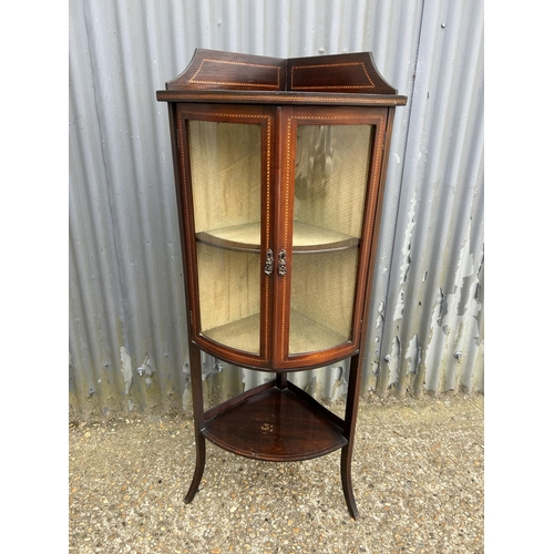 118 - An inlaid mahogany bow front corner cabinet