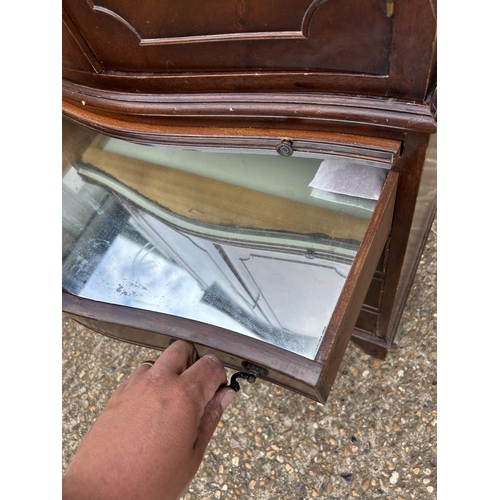 119 - A reproduction mahogany two section drinks cabinet with glazed interior