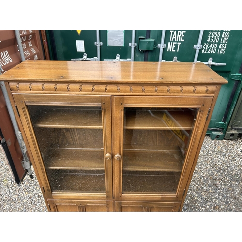 120a - An ercol golden dawn glazed bookcase