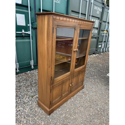 120a - An ercol golden dawn glazed bookcase