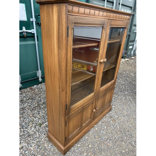 120b - An ercol golden dawn glazed bookcase