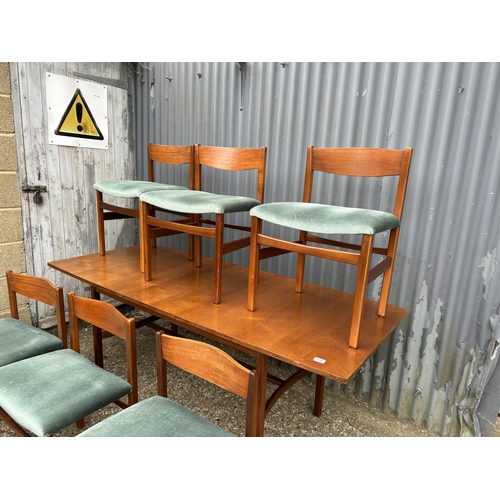 136 - A mid century teak refectory style dining table by ARCHIE SHINE 190x80x72 together with a set of six... 