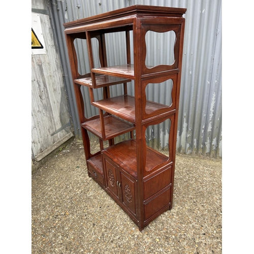 137 - An Oriental hardwood  double sided bookcase with cupboards and drawer to each side 100x40 x168