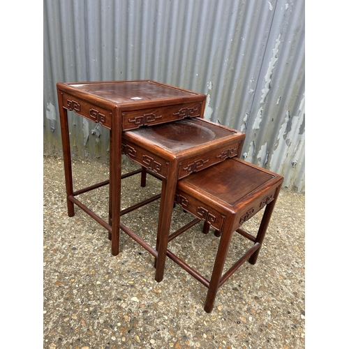 138 - An Oriental hardwood nest of three occasional tables