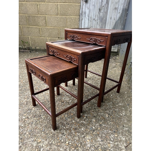 138 - An Oriental hardwood nest of three occasional tables