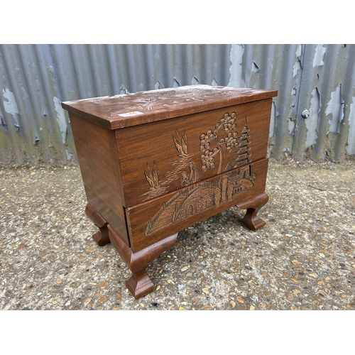 144 - An oriental camphor wood sewing box with contents