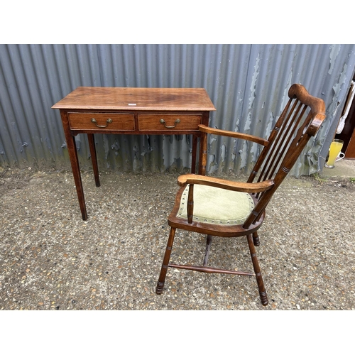 145 - A Victorian mahogany two drawer writing table together with a mahogany carver chair  80x45x77