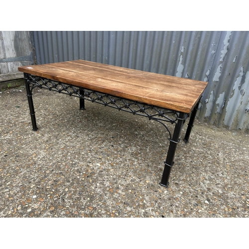 146 - A iron framed coffee table with hardwood top