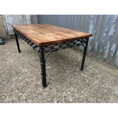 146 - A iron framed coffee table with hardwood top