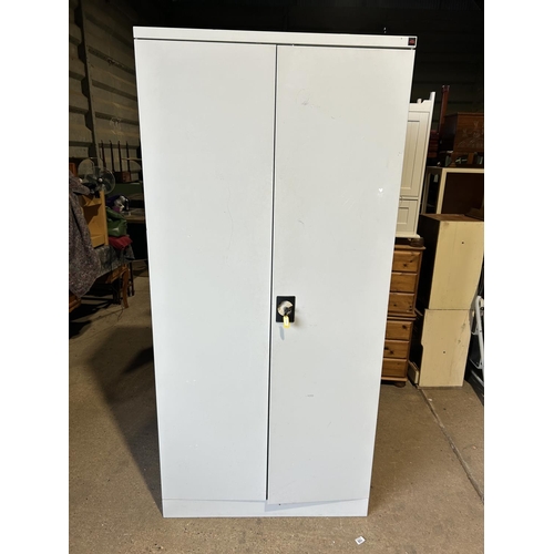 155 - A metal two door office cupboard  with key and shelves