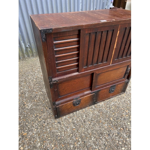 170 - An Oriental double sided sideboard with drawers and sliding doors to each side  88x44x90