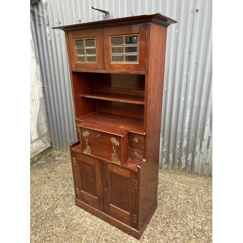 194 - A mahogany arts and crafts design cabinet in the style of E W GODWIN  72x43 x175