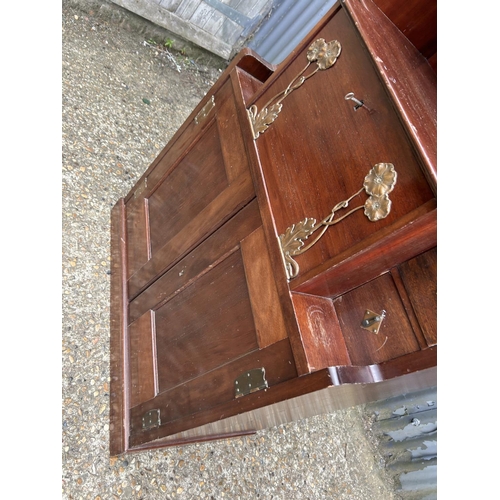 194 - A mahogany arts and crafts design cabinet in the style of E W GODWIN  72x43 x175