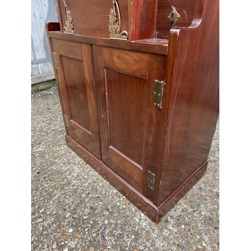 194 - A mahogany arts and crafts design cabinet in the style of E W GODWIN  72x43 x175