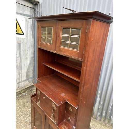 194 - A mahogany arts and crafts design cabinet in the style of E W GODWIN  72x43 x175