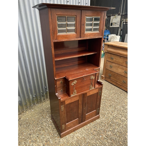 194 - A mahogany arts and crafts design cabinet in the style of E W GODWIN  72x43 x175