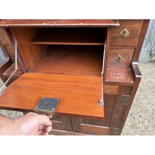 194 - A mahogany arts and crafts design cabinet in the style of E W GODWIN  72x43 x175