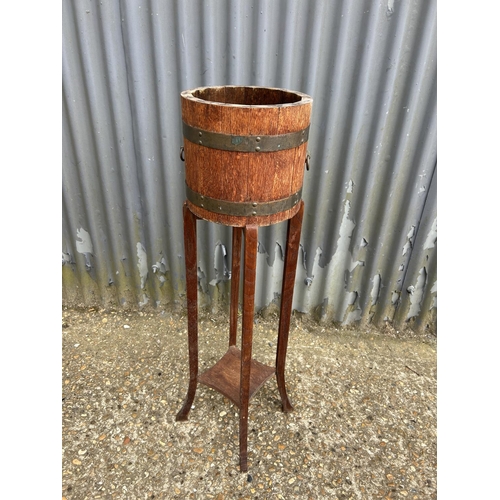 198 - A brass banded oak plant stand 96 cm tall