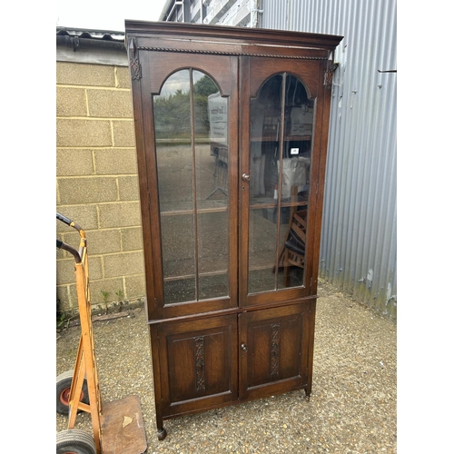 218 - A carved oak glazed bookcase 91x27x195