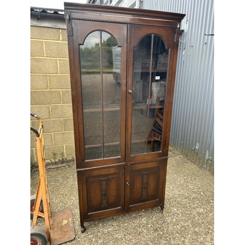 218 - A carved oak glazed bookcase 91x27x195