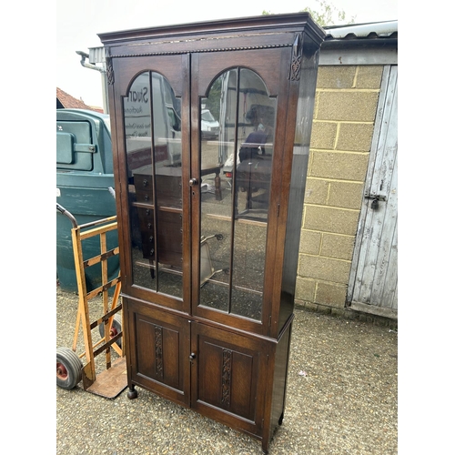 218 - A carved oak glazed bookcase 91x27x195