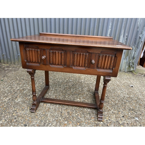 221 - An oak linenfold two drawer table 90x50 x74