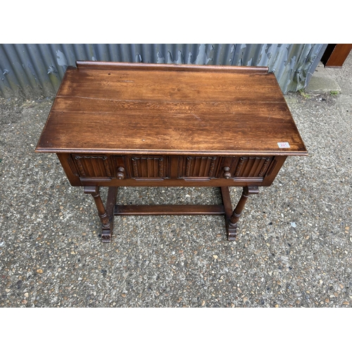 221 - An oak linenfold two drawer table 90x50 x74