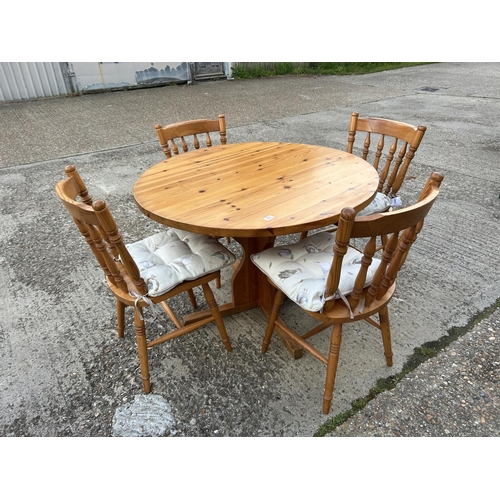 23 - Circular pine table and four chairs, table 105cms diameter