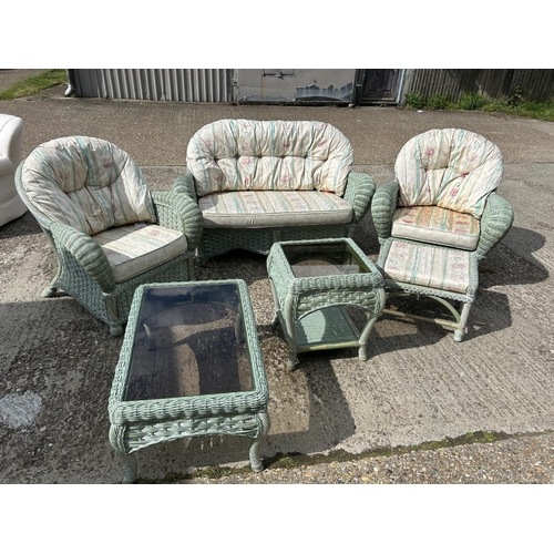24 - Green wicker 6 piece conservatory suite, consisting a sofa, two armchairs, a footstool and two glass... 