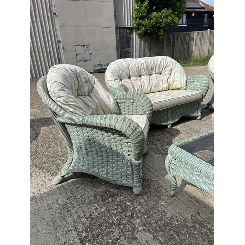 24 - Green wicker 6 piece conservatory suite, consisting a sofa, two armchairs, a footstool and two glass... 