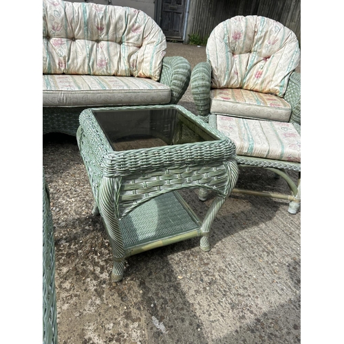 24 - Green wicker 6 piece conservatory suite, consisting a sofa, two armchairs, a footstool and two glass... 