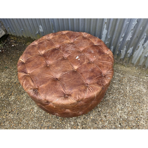 3 - A large swivel brown leather chesterfield footstool 100cm