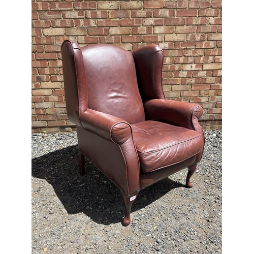 368 - A dark brown leather wing back armchair