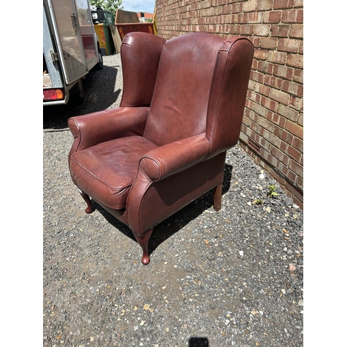 368 - A dark brown leather wing back armchair