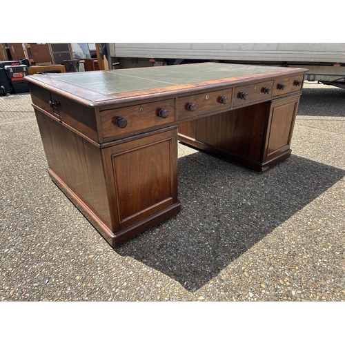 63 - A large Victorian mahogany partners desk with drawers to the front and cupboard doors to the reverse... 