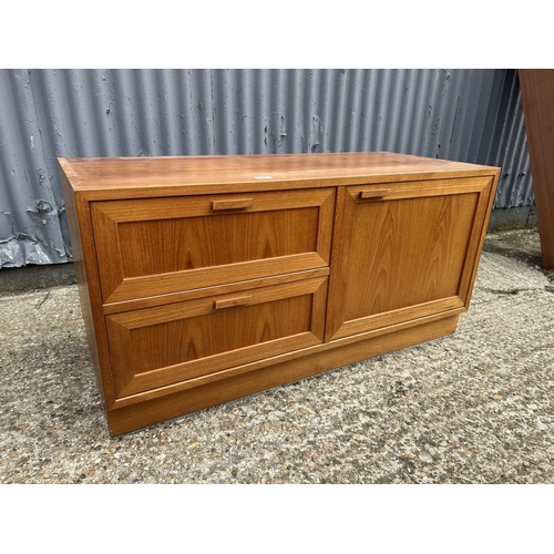 76 - A good quality danish teak multi sectional lounge unit with glazed tops over sideboard and glazed cu... 