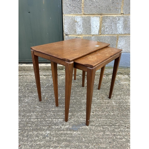 113 - A teak nest of two tables