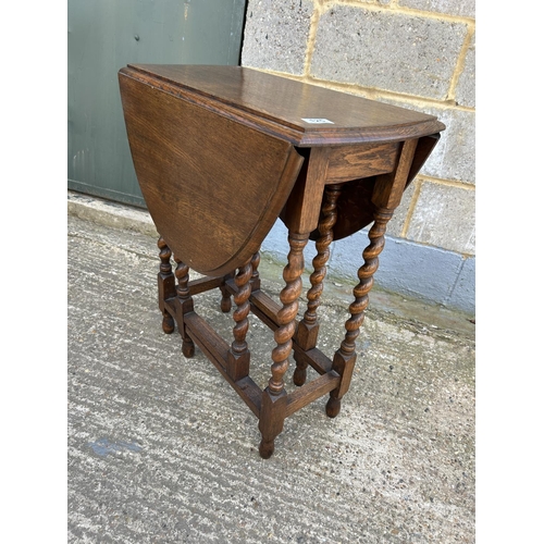 125 - An oak barley twist gateleg table