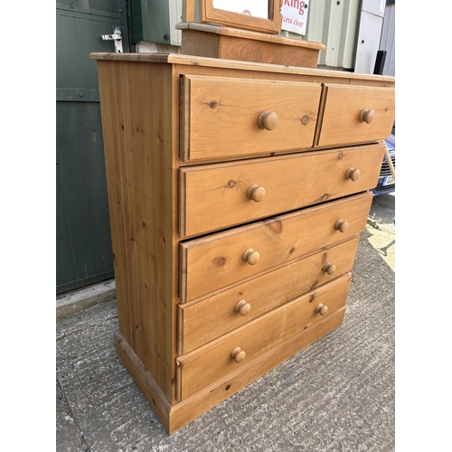 128 - A solid pine chest of six drawers together with pine swing mirror 100x46x115