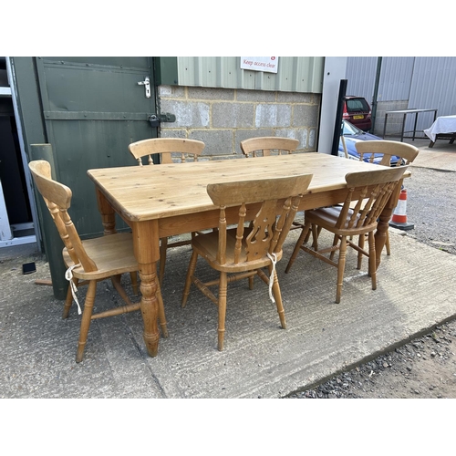 129 - A farmhouse style pine table fitted with drawer together with six pine chairs 184x86x77