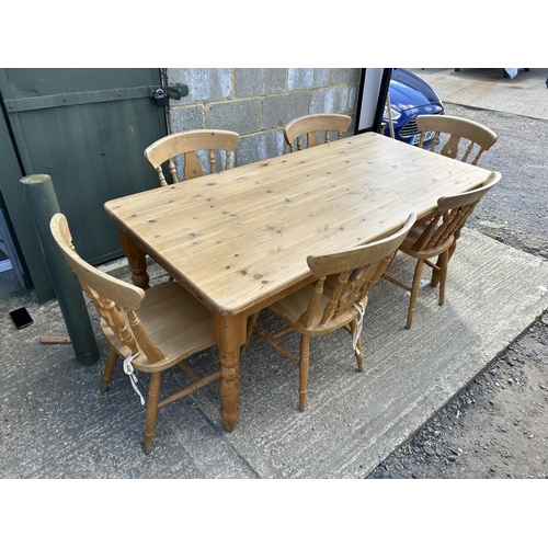 129 - A farmhouse style pine table fitted with drawer together with six pine chairs 184x86x77