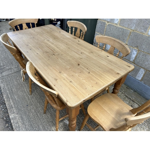 129 - A farmhouse style pine table fitted with drawer together with six pine chairs 184x86x77