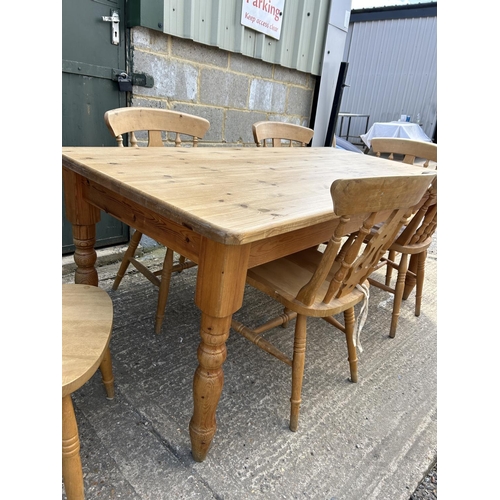 129 - A farmhouse style pine table fitted with drawer together with six pine chairs 184x86x77