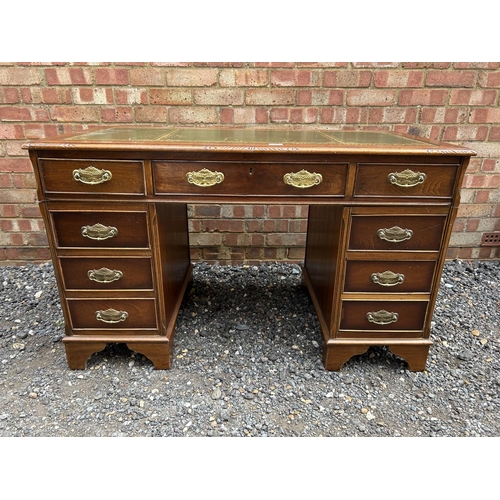 14 - A reproduction mahogany twin pedestal desk with a green leather top 123x66x77