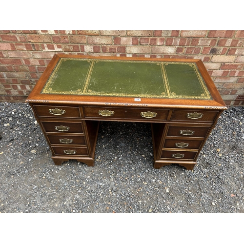 14 - A reproduction mahogany twin pedestal desk with a green leather top 123x66x77