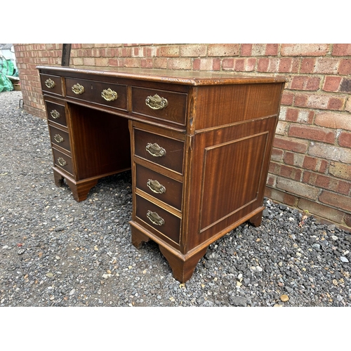 14 - A reproduction mahogany twin pedestal desk with a green leather top 123x66x77