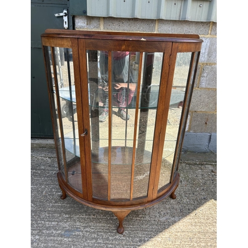 143 - A walnut bow front china cabinet