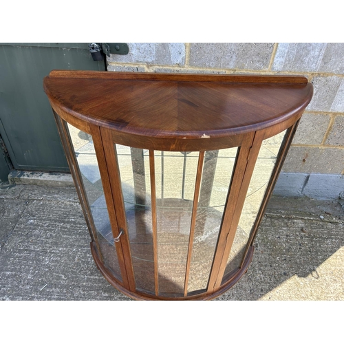 143 - A walnut bow front china cabinet