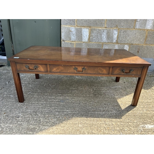 144 - A reproduction mahogany three drawer coffee table 120x60x 47