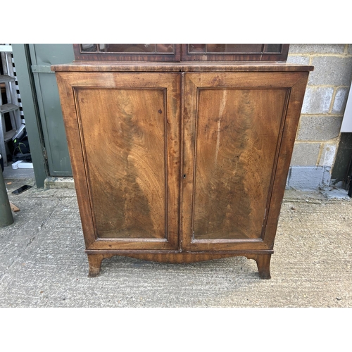 145 - A early victorian mahogany glazed bookcase cupboard  104x53x220